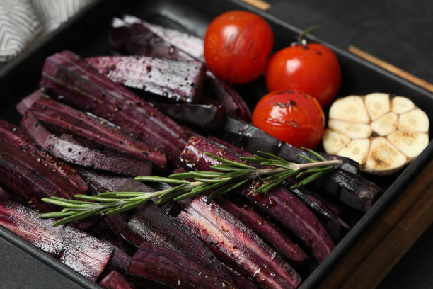 istock Cut raw carrot with vegetables and rosemary in baking dish, closeup 1355962278