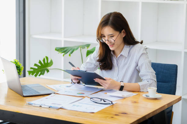 istock Work from home. Start a small business owner by using pens and documents, personal business income and computers to work. 1355963089