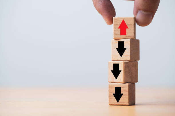 istock Hand holding red up arrow which it opposite direction from black down arrow for business disruption and leadership concept. 1355963224