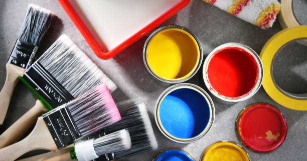 istock Paintbrushes of different size and paint cans 1355964586