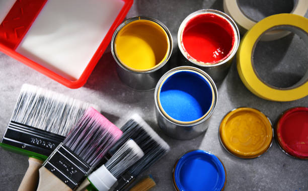 istock Paintbrushes of different size and paint cans 1355964626