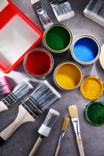 istock Paintbrushes of different size and paint cans 1355964670