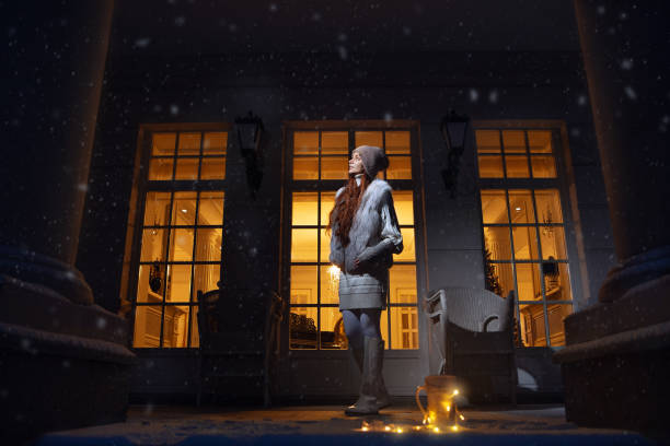 Christmas girl outdoor portrait. Winter woman in a park of her house in the night