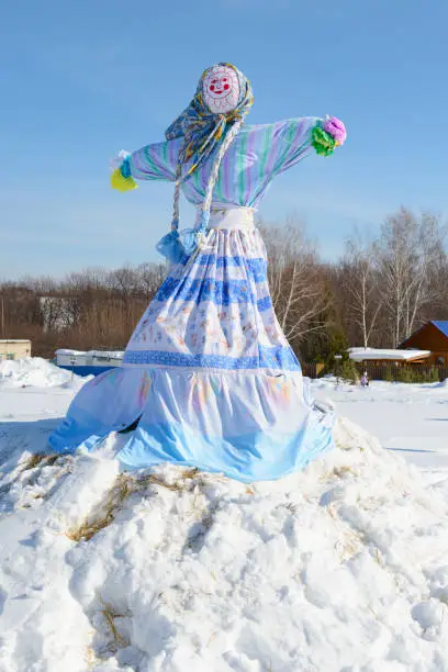 Decorated and dressed effigy of Maslenitsa on a sunny winter day