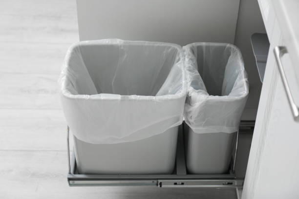 istock Open cabinet with empty trash bins for separate waste collection in kitchen 1355965342