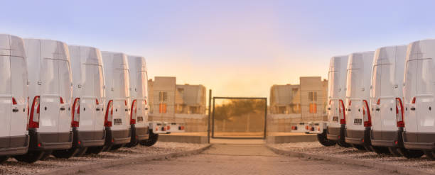 commercial delivery vans in two rows 2 commercial delivery vans parked in two rows. Transporting service company. car carrier semi stock pictures, royalty-free photos & images