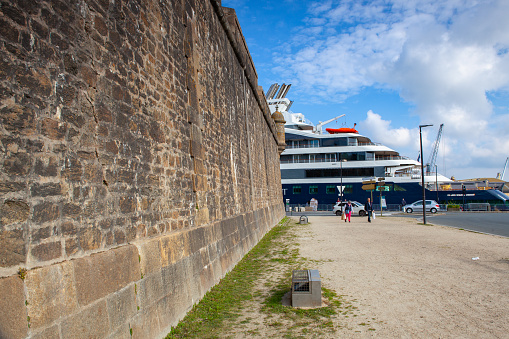 Saint Malo, France -  15 October, 2021:  Luxury cruiser in the  port near the roundabout,