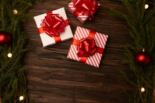 istock three Christmas boxes on a wooden background . photo with a copy-space 1355970556