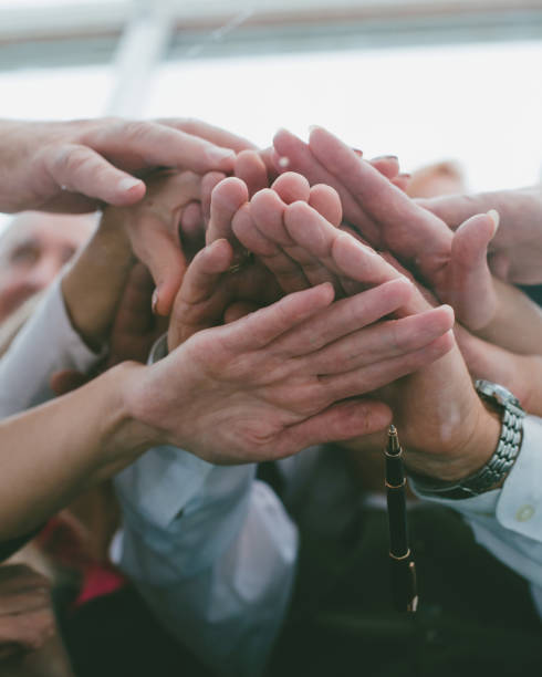 istock close up. a team of experienced employees showing their unity 1355970817