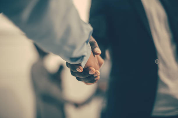 close up. strong male handshake on the office background