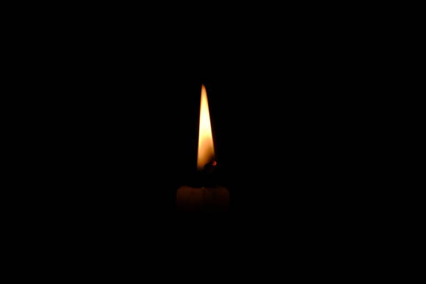 istock Single fire, black background of candle 1355970948