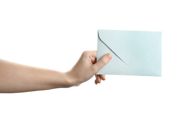istock Woman holding paper envelope on white background, closeup 1355971259