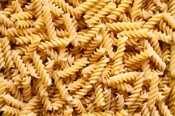 Stack of uncooked fusilli pasta stock photo