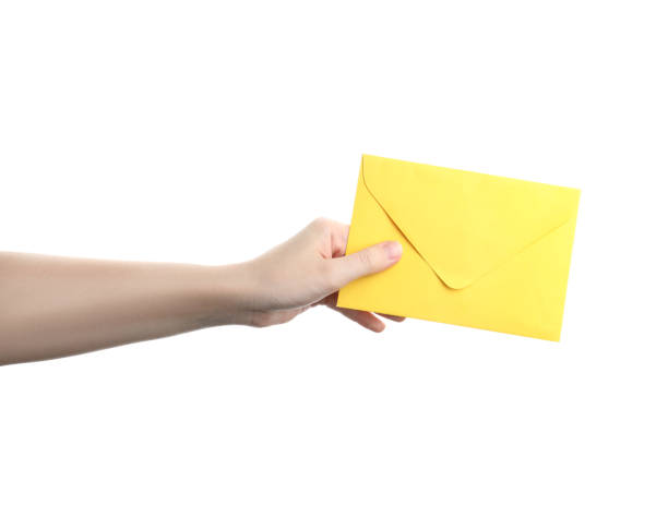 istock Woman holding yellow paper envelope on white background, closeup 1355971941