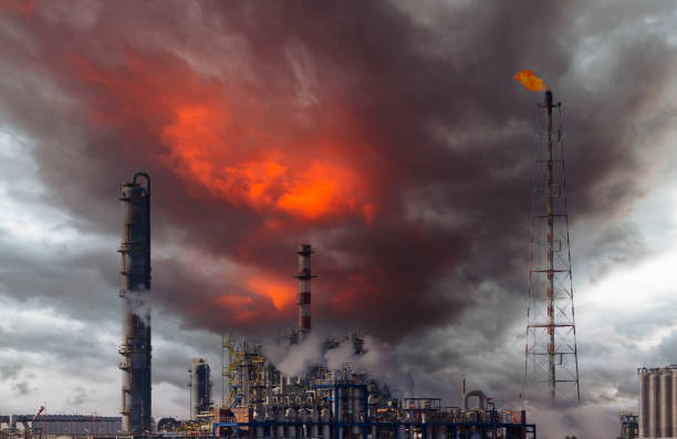 Fire from a gas torch and smoke stacks Fire from a gas torch and smoke in the chemical industry, pollution and global warming fuel crisis stock pictures, royalty-free photos & images