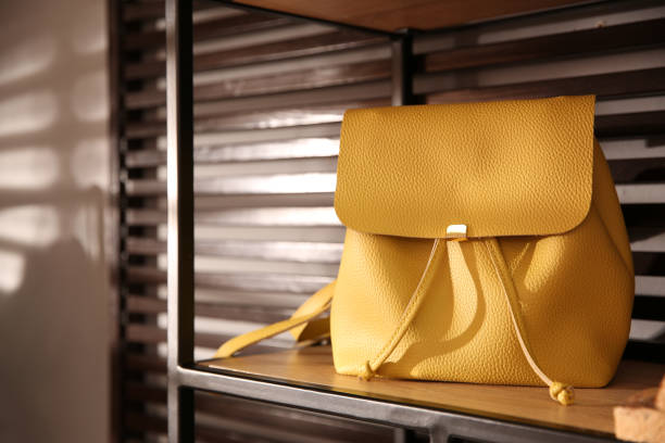 istock Stylish woman's bag on shelf in boutique 1355972319