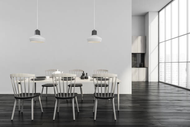 istock Modern black and white dining room with panoramic kitchen on background 1355972423