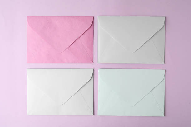 istock Colorful paper envelopes on pink background, flat lay 1355972544