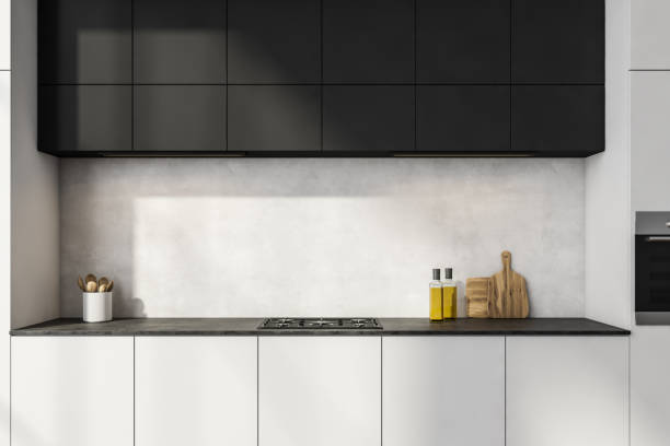 istock Black and white kitchen cabinet with concrete backsplash 1355972561