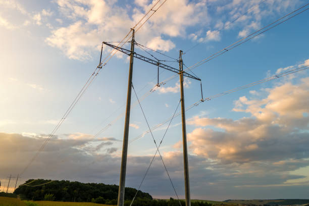 istock High voltage tower with electric power lines at sunset. 1355972595