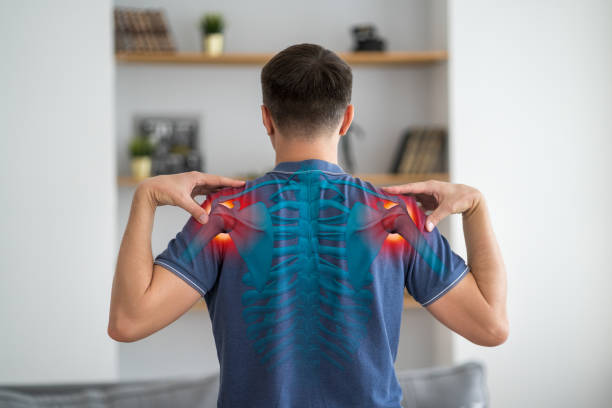 Shoulder-scapular periarthritis, shoulder blades pain, joint inflammation, human skeleton, man with backache at home stock photo