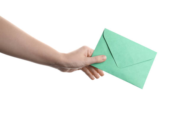 istock Woman holding green paper envelope on white background, closeup 1355973688