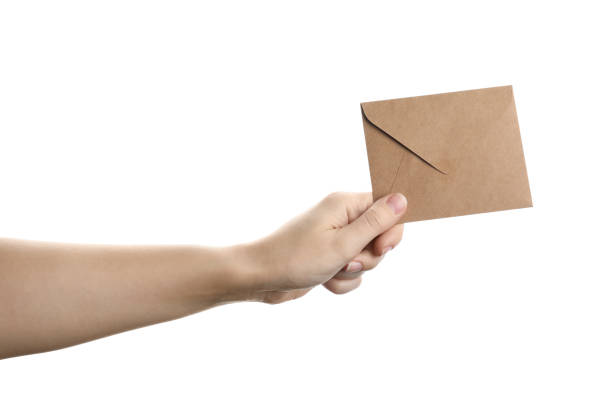 istock Woman holding kraft paper envelope on white background, closeup 1355974749