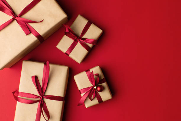 istock Gift boxes wrapped in craft paper with ribbon and bow 1355974778