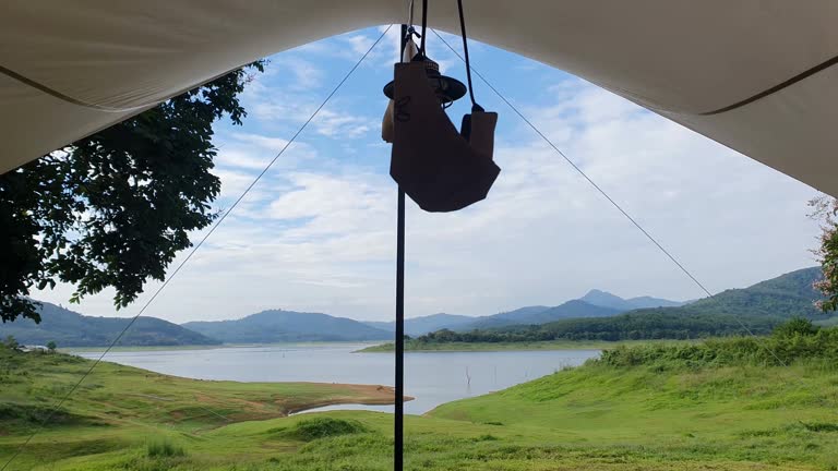 Personal perspective looking through tent to lake view.