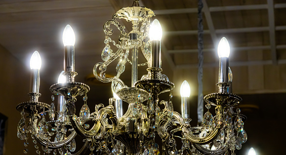 A miniature chandelier with sparkling crystal accents and delicate metalwork.