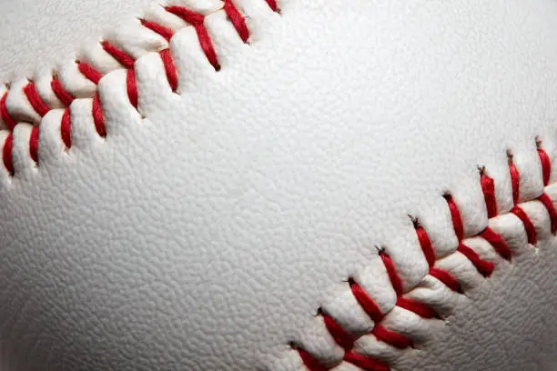 Photo of Macro close-up baseball ball with stiches and seam