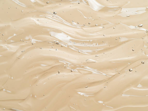 istock Transparent cosmetic gel waves smears on nude 1355976902