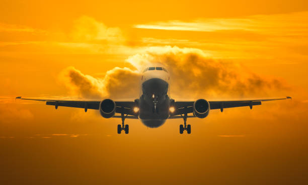 istock Passenger plane taking off above the clouds at sunset 1355977099