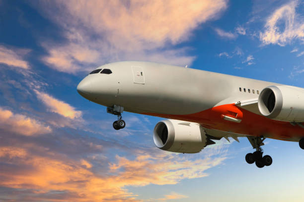 istock Passenger plane taking off above the clouds at sunset 1355977111