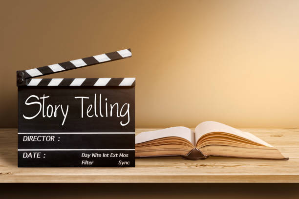 Story Telling.Text title on film slate and old book on wooden background. Story Telling.Text title on film slate and old book on wooden background. cinematography stock pictures, royalty-free photos & images