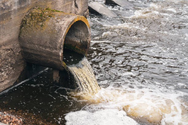 istock Dirty water flows from the pipe into the river, environmental pollution. Sewerage, treatment facilities 1355981613