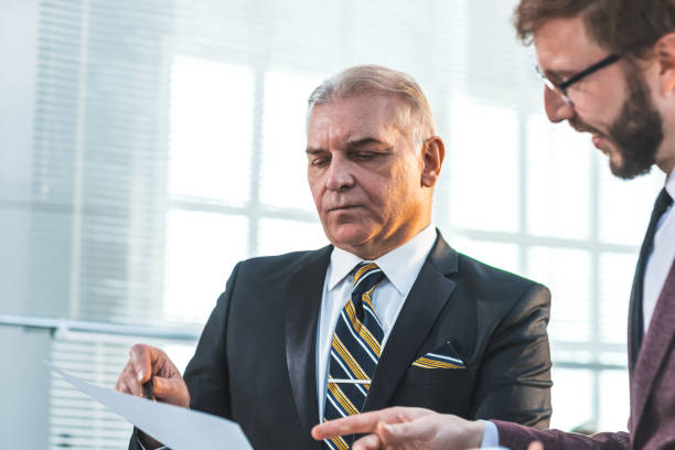 istock close up. serious business colleagues discussing new data 1355982085