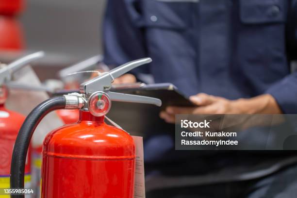Engineer Are Checking And Inspection A Fire Extinguishers Tank In The Fire Control Room For Safety Training And Fire Prevention Stock Photo - Download Image Now