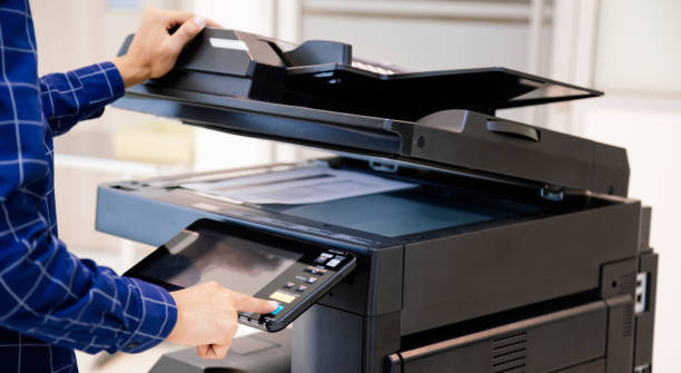 istock Businessmen press button on the panel for using photocopier or printer for printout and scanning document paper at office. 1355985113