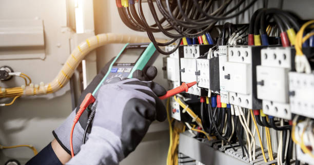 istock Electrician engineer tests electrical installations and wires on relay protection system. Adjustment of scheme of automation and control of electrical equipment. 1355985239