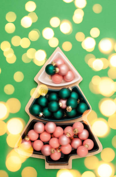 istock Christmas decorations balls on green background with bokeh lights 1355987026