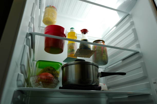 istock Pot, cans and groceries in the refrigerator. 1355987437