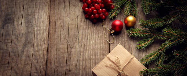 istock Christmas tree with gift box and decorations on wooden background 1355988380