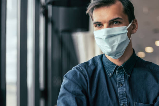 istock business colleagues in protective masks working with financial documents 1355990156