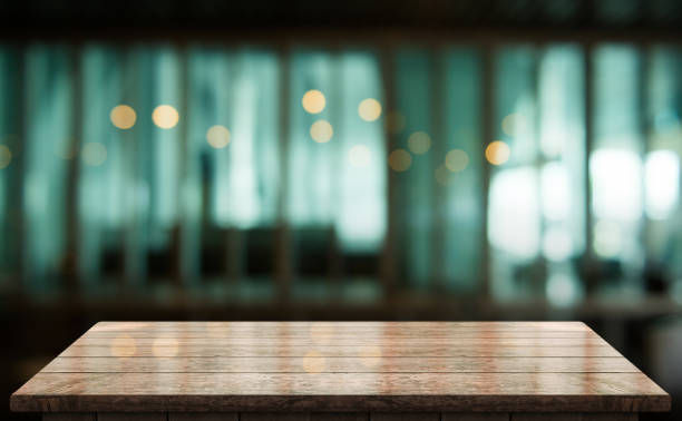 istock Empty wooden table top with lights bokeh on blur restaurant background 1355993146