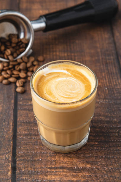 Cortado coffee with coffee beans next to it. Traditional coffee in Spain. stock photo