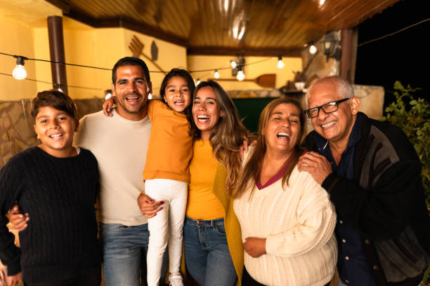 Happy Hispanic family enjoying holidays together at home stock photo