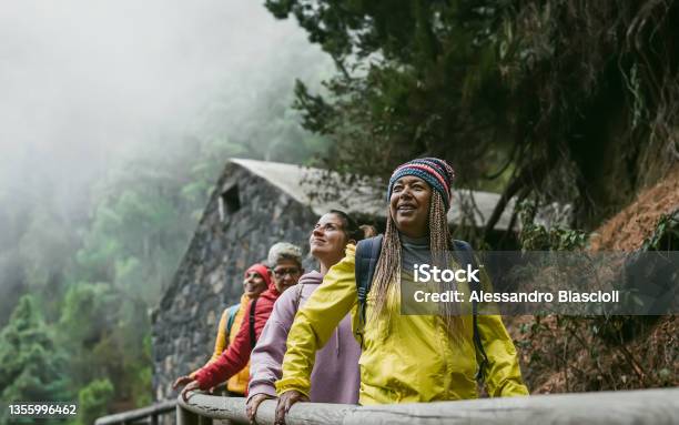 Group Of Women With Different Ages And Ethnicities Having Fun Walking In Foggy Forest Adventure And Travel People Concept Stock Photo - Download Image Now