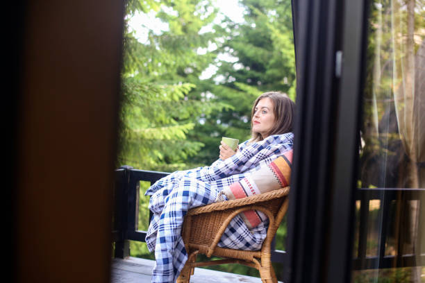 istock Young woman enjoying a hot drink 1355998788