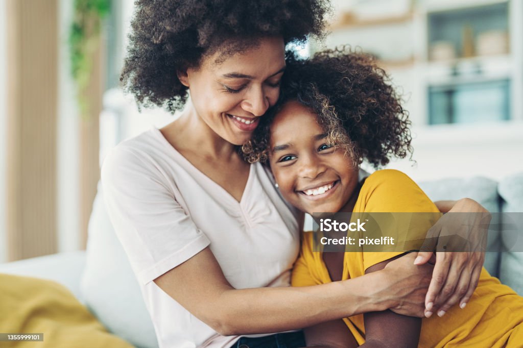 Loving mother Smiling mother embracing her daughter Child Stock Photo